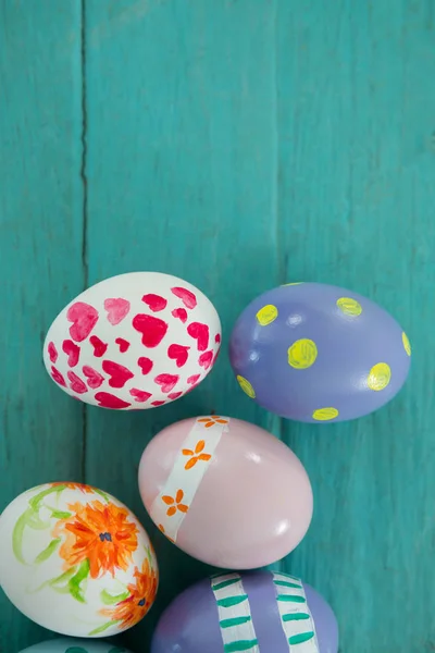 Painted Easter eggs on wooden surface — Stock Photo, Image