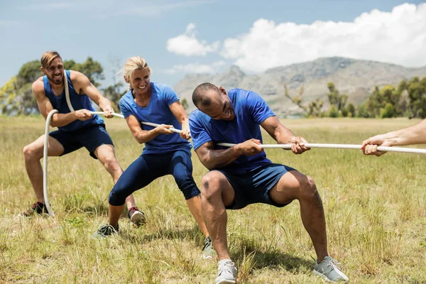 Personnes jouant au remorqueur de guerre pendant le cours de formation d'obstacles — Photo