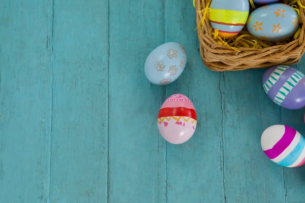 Various Easter eggs arranged in wicker basket — Stock Photo, Image