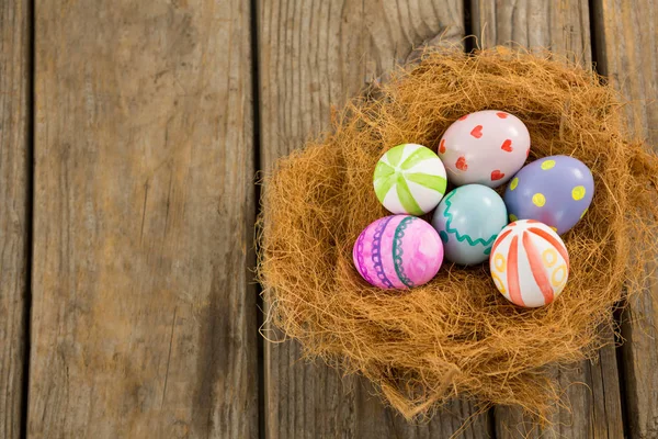 Painted Easter eggs in nest — Stock Photo, Image