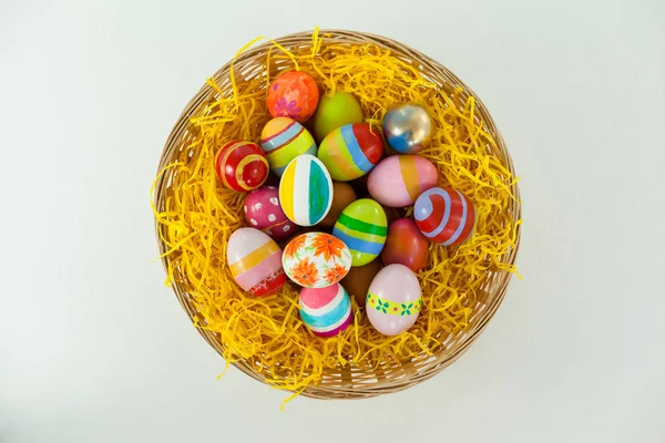 Painted easter eggs in basket — Stock Photo, Image