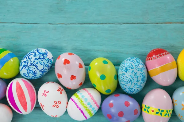 Painted Easter eggs on wooden plank — Stock Photo, Image