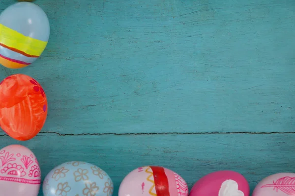Various Easter eggs arranged on wooden surface — Stock Photo, Image