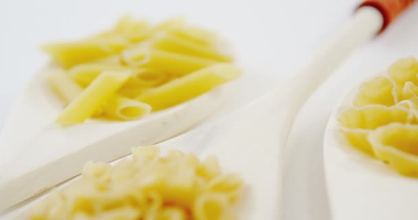 Pasta varia in cucchiai su fondo bianco — Video Stock