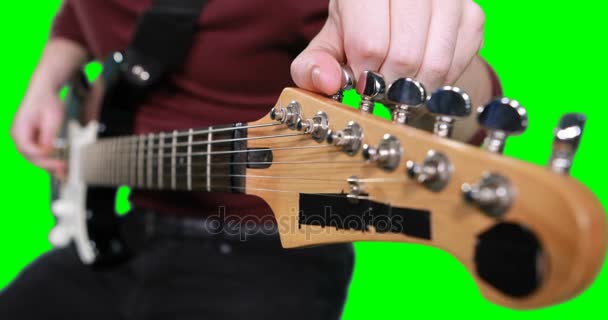 Mid section male musician adjusting tuners — Stock Video