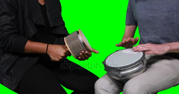 Mid section of musicians playing cabasa and drum — Stock Video