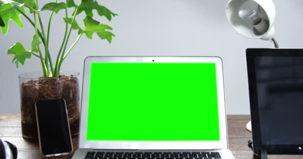 Laptop, mobile phone and digital tablet arranged on wooden table — Stock Video