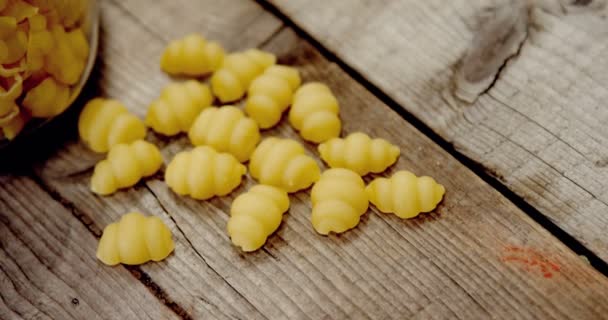 Gnocchi pasta in jar on wooden background — Stock Video