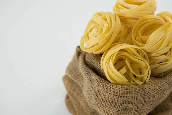 Fettuccine pasta in sack — Stock Photo, Image