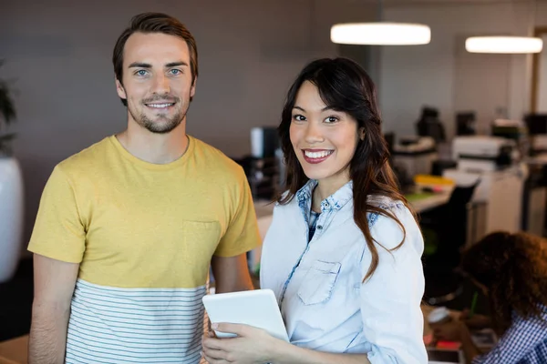 Smiling creative business people standing at office — Stock Photo, Image