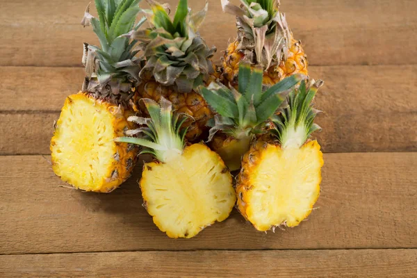 Halbierte Ananas auf Holztisch — Stockfoto