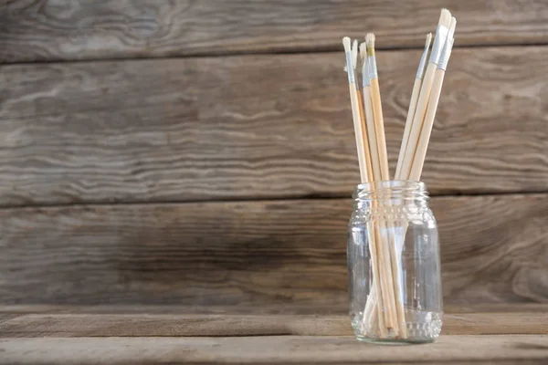 Various paintbrush in a glass jar — Stock Photo, Image