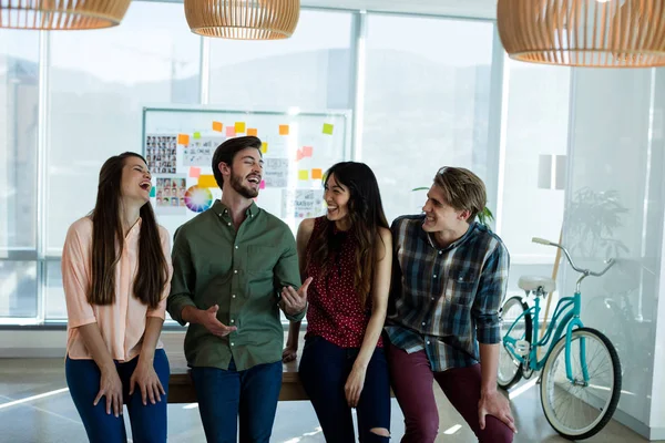 Smiling creative business team interacting with each other — Stock Photo, Image