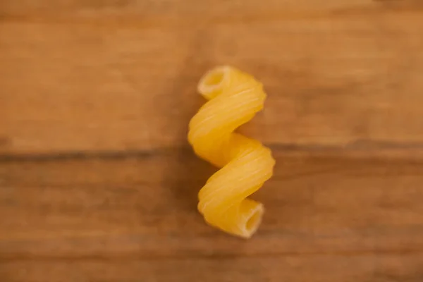 Cavatappi pasta on wooden table — Stock Photo, Image