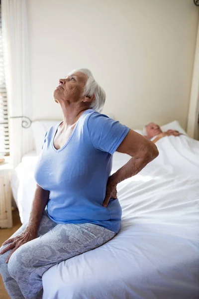 Senior woman suffering from backache in the bedroom — Stock Photo, Image