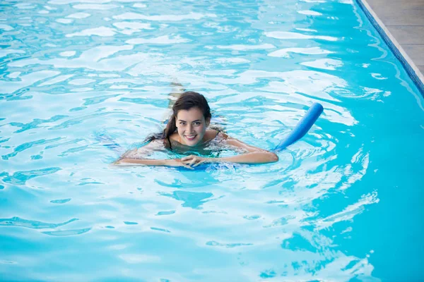 Young woman swimming with inflatable tube — Stock Photo, Image