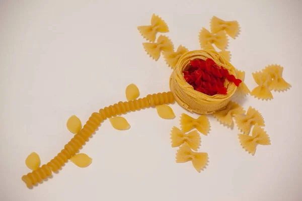 Varieties of pasta making a flower — Stock Photo, Image