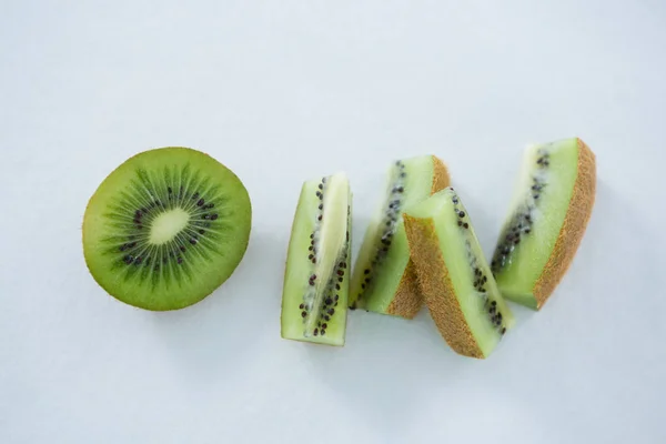 Pieces of kiwis on white background — Stock Photo, Image