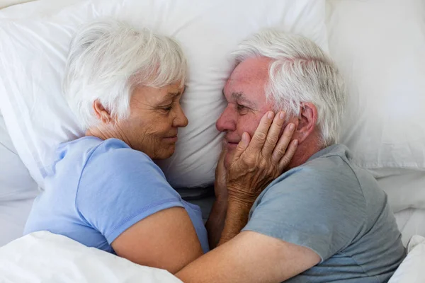 Pareja mayor abrazándose en el dormitorio —  Fotos de Stock