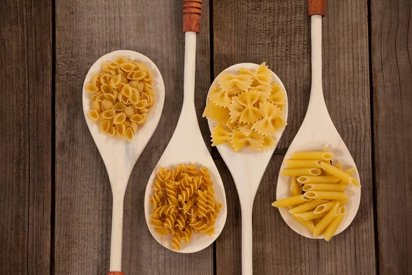 Spoons filled with varieties of pasta — Stock Photo, Image