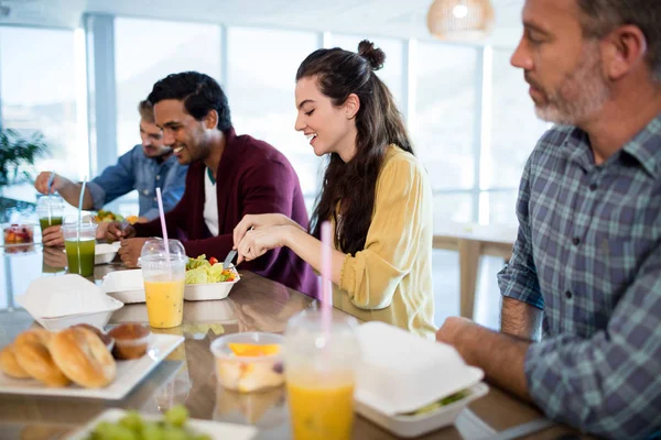Creative business team having meal in office — Stock Photo, Image