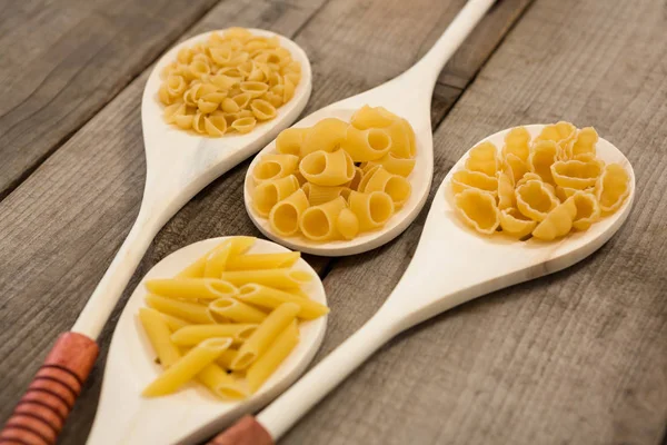 Spoons filled with varieties of pasta — Stock Photo, Image