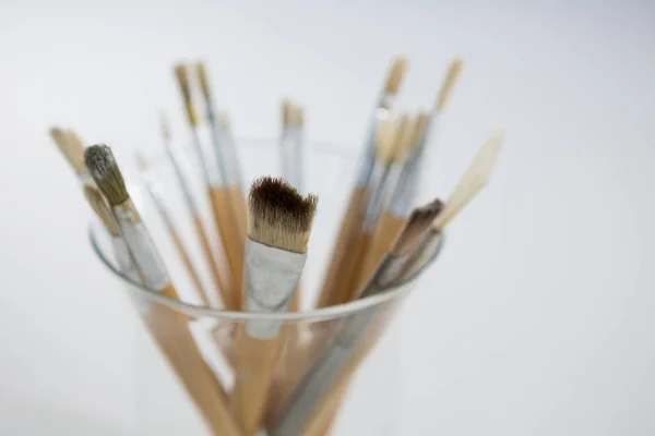 Close-up of various paintbrush in a glass jar — Stock Photo, Image