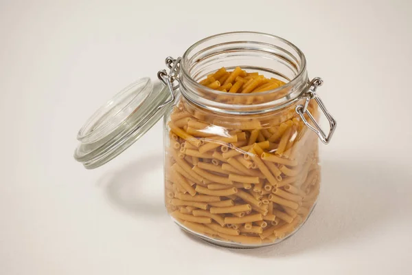 Macaroni pasta in a jar with open lid — Stock Photo, Image
