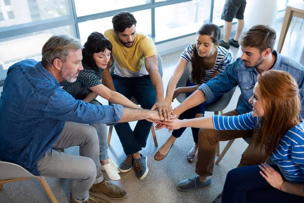Creative business team putting their hands together — Stock Photo, Image