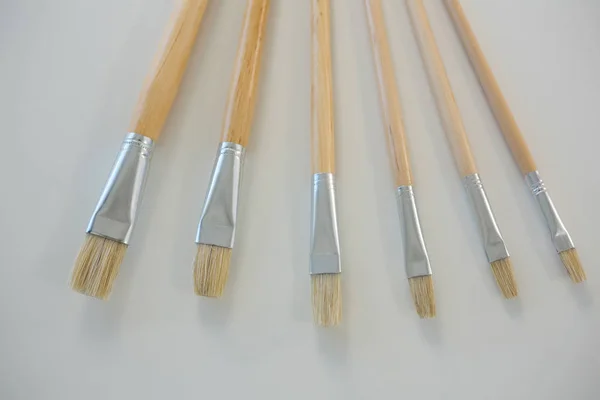 Various paintbrushes arranged in a row — Stock Photo, Image