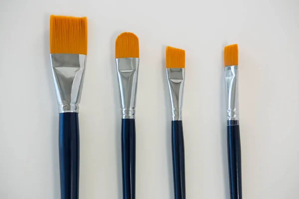 Various paintbrushes arranged in a row — Stock Photo, Image