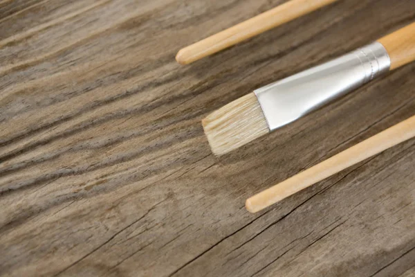 Paintbrushes on wooden surface — Stock Photo, Image