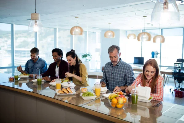 Creative business team having meal — Stock Photo, Image