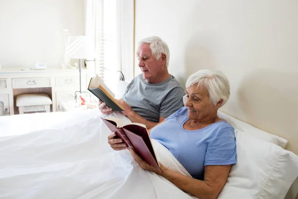 在卧室里的年长夫妇读书 — 图库照片