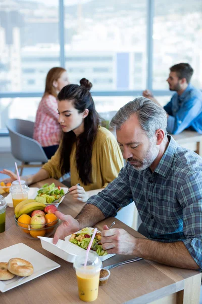 Creative business team having meal — Stock Photo, Image