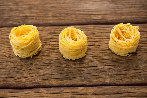 Tagliatelle pasta arranged in a row — Stock Photo, Image