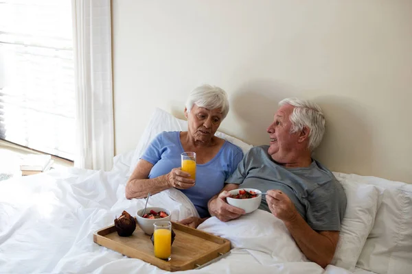 Senior couple having breakfast in the bedroom — Stock Photo, Image