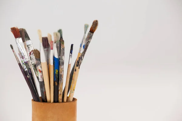 Varieties of paint brushes in jar — Stock Photo, Image