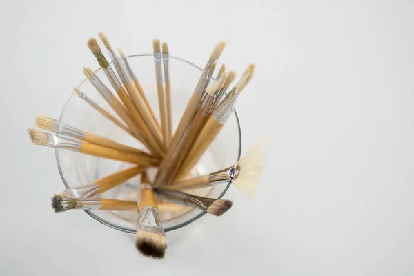 Close-up of various paintbrush in a glass jar — Stock Photo, Image