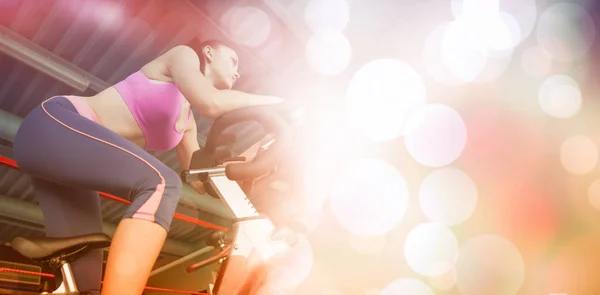 Woman working out at spinning class — Stock Photo, Image