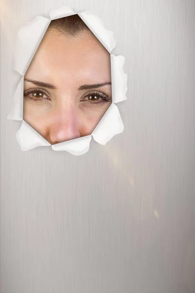 Woman looking out of hole — Stock Photo, Image