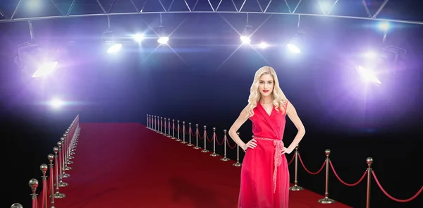 Composite image of elegant blonde standing hands on hips — Stock Photo, Image