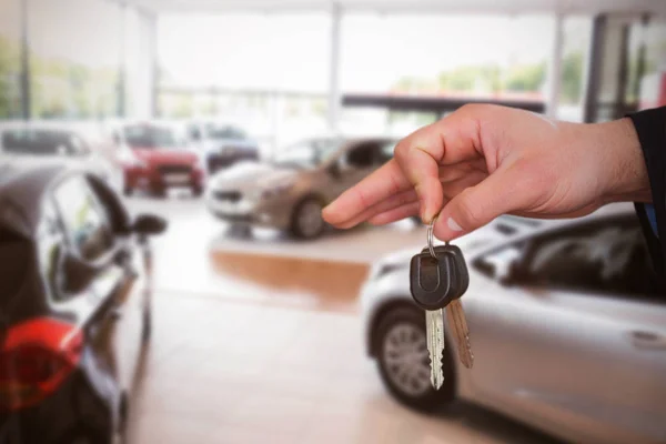 Car dealer holding keys — Stock Photo, Image