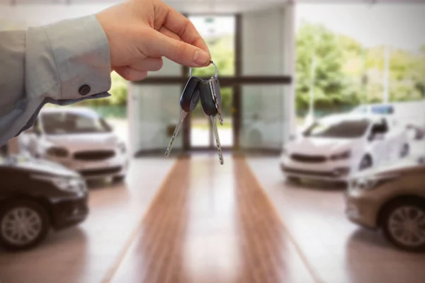 Car dealer holding keys — Stock Photo, Image