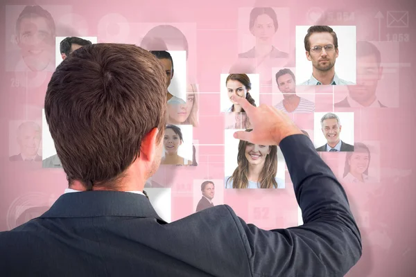 Composite image of businessman pointing with his finger — Stock Photo, Image