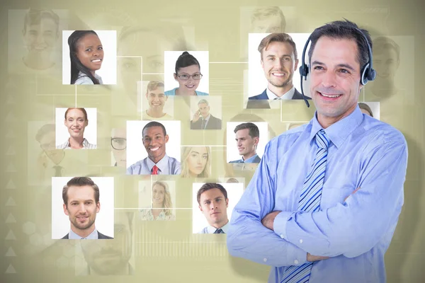 Composite image of smiling businessman using headset — Stock Photo, Image