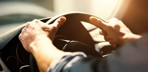 Przycięte ręce mężczyzny trzymającego kierownicy — Zdjęcie stockowe