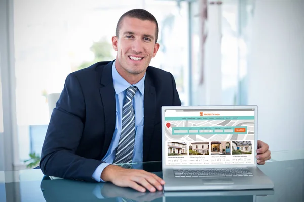 Businessman showing laptop — Stock Photo, Image