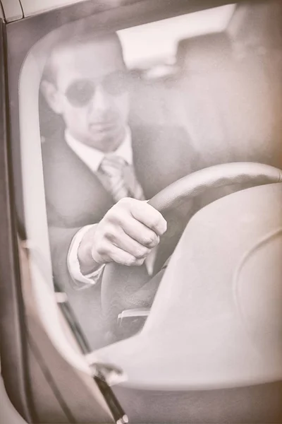 Businessman on drivers seat — Stock Photo, Image