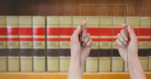 Mans hands holding glass tablet in Library — Stock Photo, Image